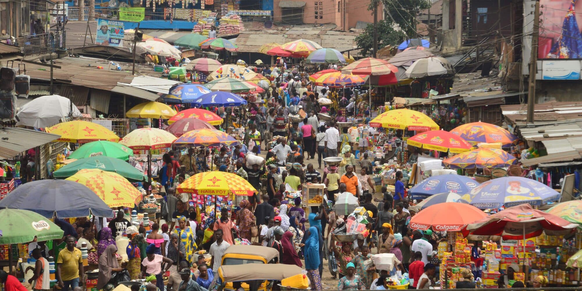 A market seen from above, dense with trading umbrellas